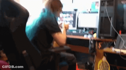 Woman With Blue Hair Sitting At Desk With Computer GIF