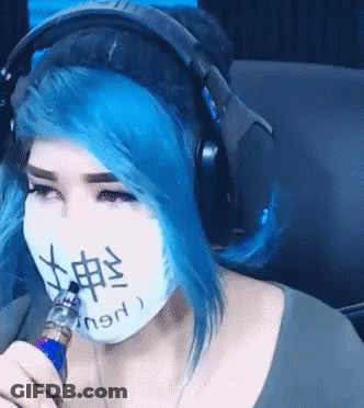 Woman With Blue Hair Wearing Headphones And Mask With Chinese Writing GIF