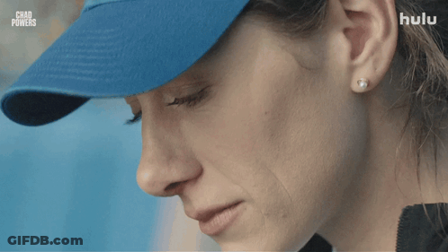 Woman With Blue Hat With Chad Powers Behind GIF