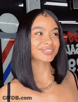 Woman With Bob Hairstyle Smiling At Barber Pole GIF