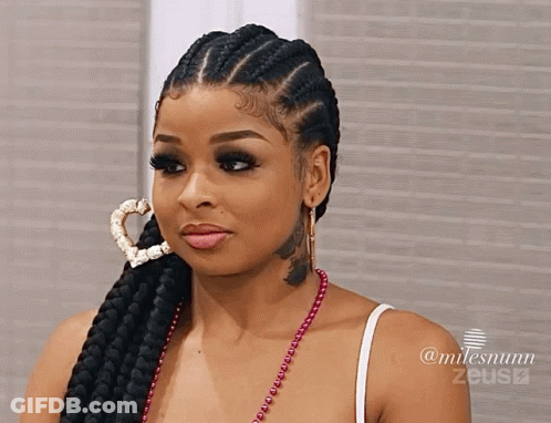 Woman With Braided Hair And Heart Hoop Earring And Neck Tattoo GIF