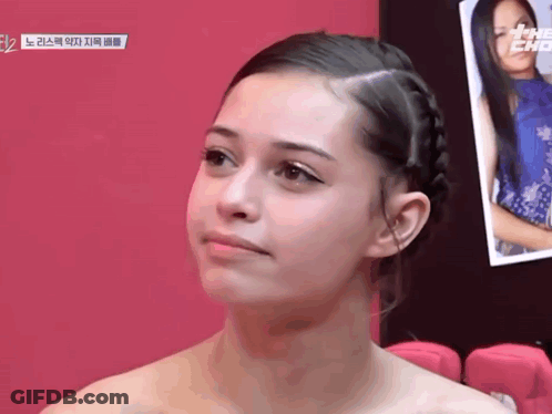 Woman With Braided Hair Looking At Camera GIF