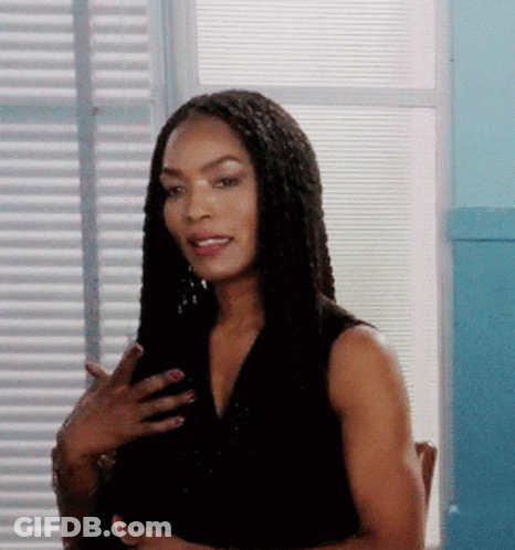 Woman With Braided Hair Standing In Front Of Window GIF