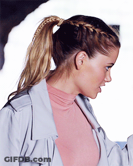 Woman With Braided Ponytail In Pink Shirt GIF
