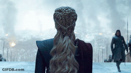 Woman With Braided Ponytail Standing In Snow GIF