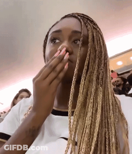 Woman With Braids And Pink Nails Covering Mouth GIF