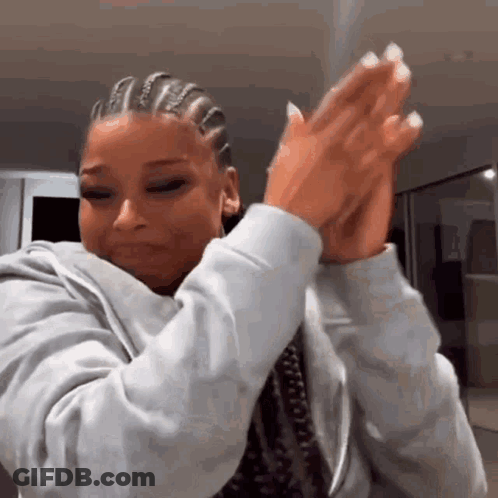 Woman With Braids Clapping And Making Funny Face GIF