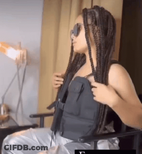 Woman With Braids In Black Vest And Sunglasses GIF