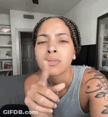 Woman With Braids Pointing At Camera GIF