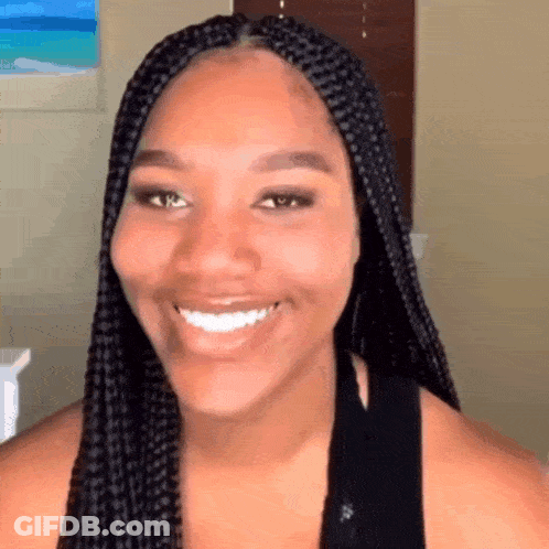 Woman With Braids Smiling In Black Shirt GIF