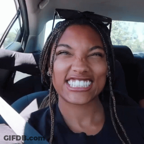 Woman With Braids Smiling In Car Back Seat GIF