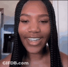 Woman With Braids Smiling In Kitchen GIF