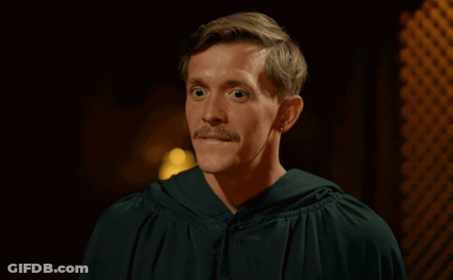 Woman With Bun And Earrings Looking At Camera GIF