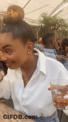 Woman With Bun Holding Whiskey Glass GIF