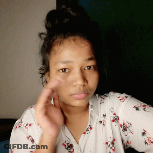 Woman With Bun In White Floral Shirt GIF
