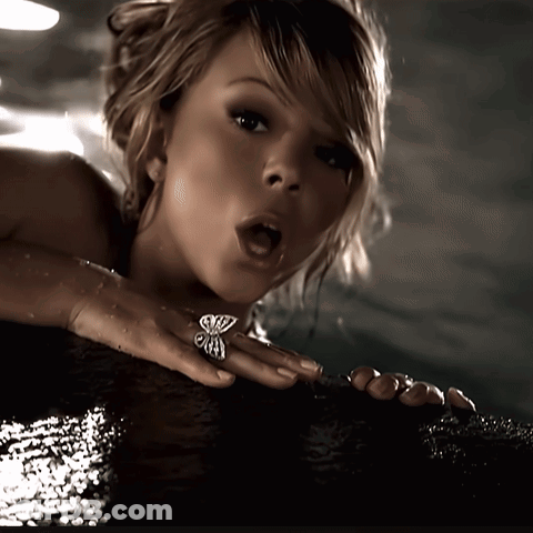 Woman With Butterfly Ring Looking At Camera GIF