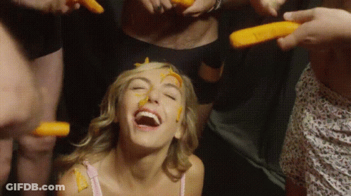 Woman With Carrots On Face Laughs GIF