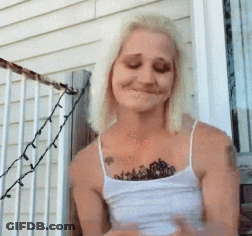 Woman With Chest Tattoo Standing On Porch GIF