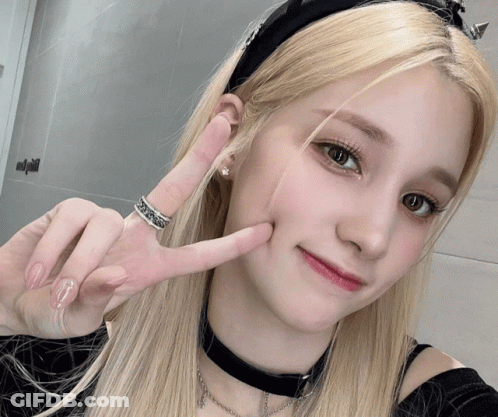 Woman With Choker And S Ring Making Peace Sign GIF
