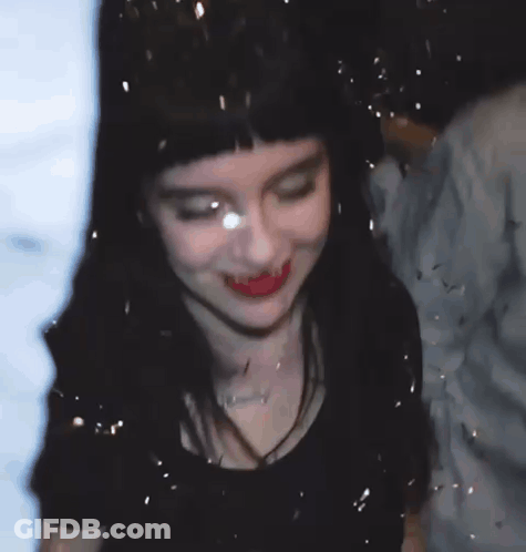 Woman With Confetti Falling On Face GIF