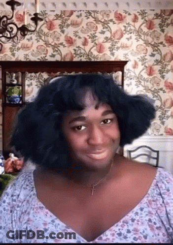Woman With Cross Necklace And Floral Shirt GIF