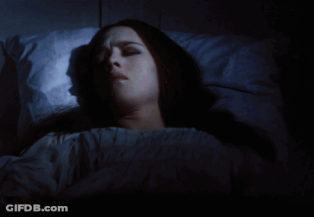 Woman With Cross Necklace Holding Head In Hands GIF
