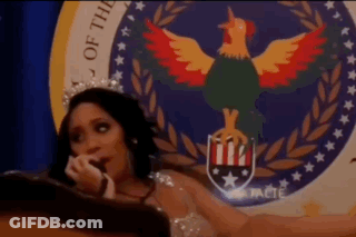 Woman With Crown Sitting In Front Of Seal With Rooster GIF