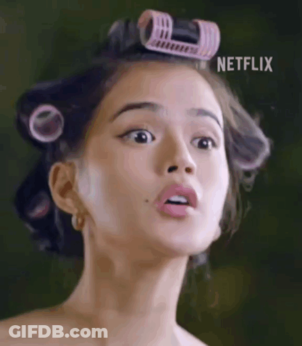 Woman With Curlers Making Funny Face GIF