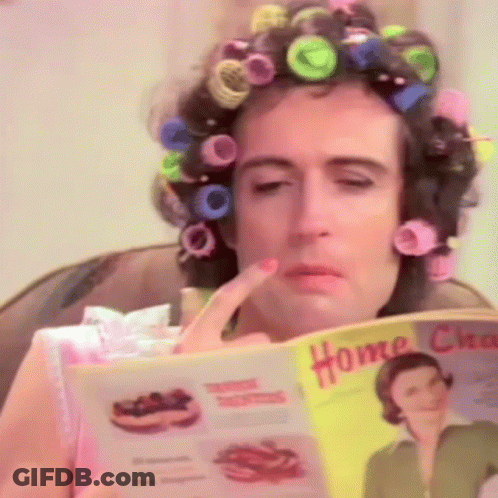 Woman With Curlers Reading Home Chores Magazine GIF