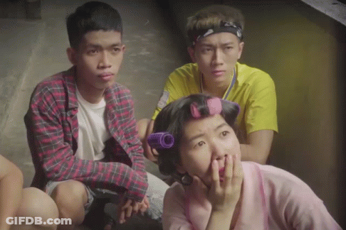 Woman With Curlers Sitting With Two Men GIF