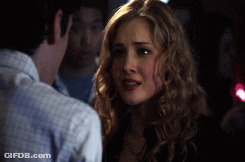 Woman With Curly Blonde Hair Looking At Man GIF