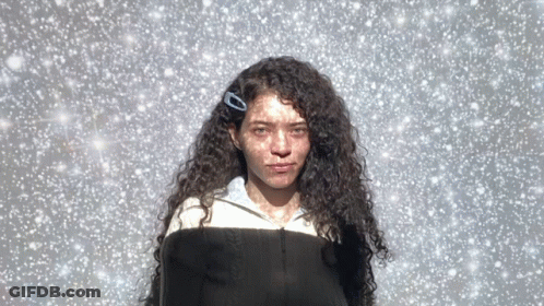 Woman With Curly Hair And Clip In Snow GIF