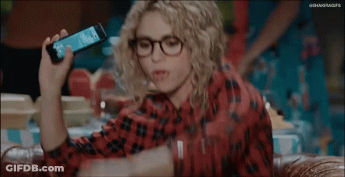Woman With Curly Hair And Glasses Arms Up On Couch GIF