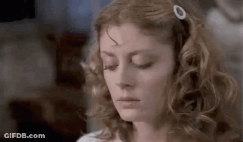 Woman With Curly Hair And Hair Clip Looking Down GIF