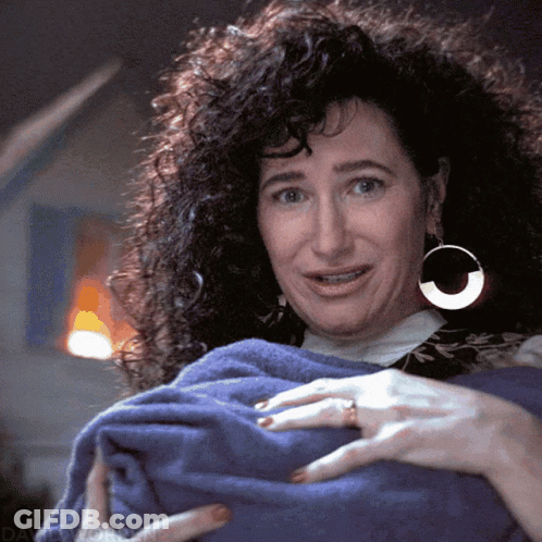 Woman With Curly Hair And Hoop Earrings Holding Blue Towel GIF