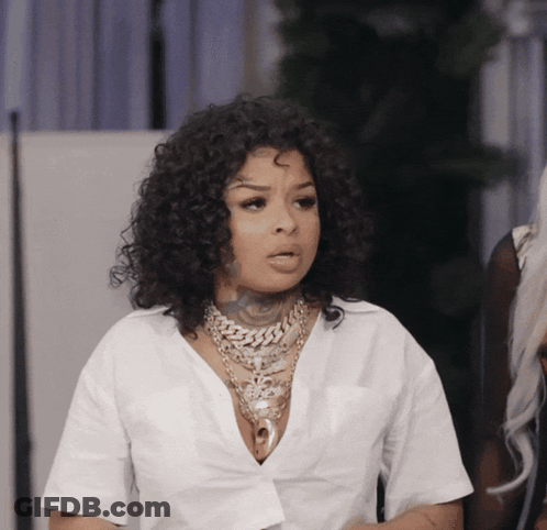 Woman With Curly Hair And White Shirt And Necklace GIF