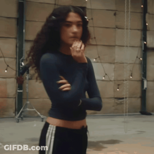 Woman With Curly Hair Arms Crossed And Ring GIF