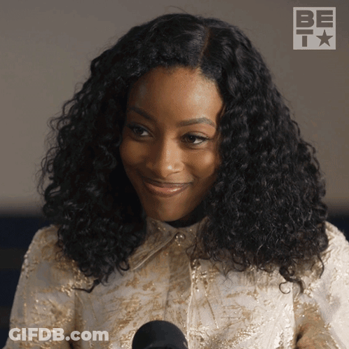 Woman With Curly Hair At Microphone GIF