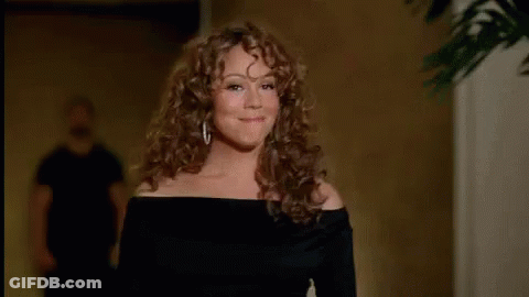 Woman With Curly Hair Blowing A Kiss GIF