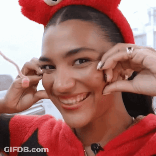 Woman With Curly Hair Drinking From Glass With Ring GIF
