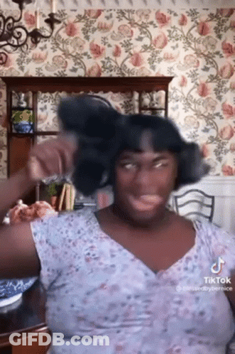 Woman With Curly Hair Drinking From Purple Bottle GIF
