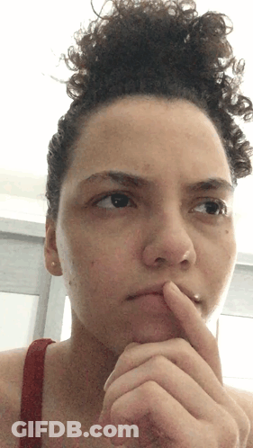 Woman With Curly Hair Finger On Chin GIF