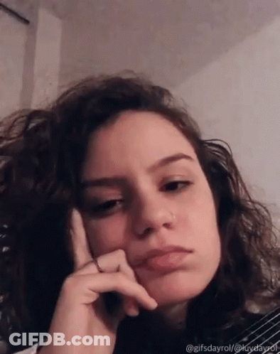 Woman With Curly Hair Funny Face Hand On Chin GIF