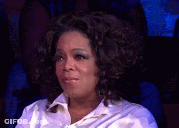 Woman With Curly Hair Funny Face In Dark Room GIF