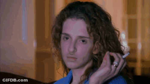 Woman With Curly Hair Holding Cigarette GIF