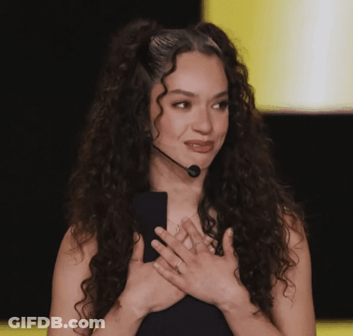 Woman With Curly Hair Holding Microphone GIF