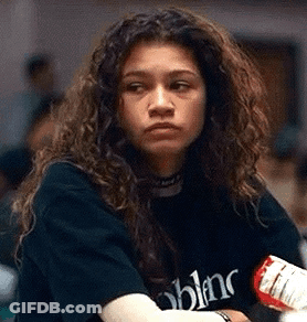 Woman With Curly Hair In Black T-Shirt Holding Bottle GIF