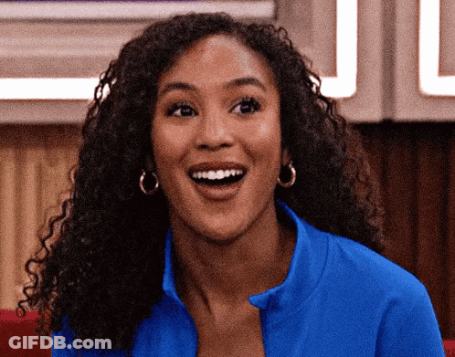 Woman With Curly Hair In Blue Shirt And Earrings GIF
