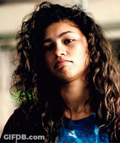Woman With Curly Hair In Blue Shirt And Red Jacket GIF
