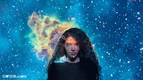Woman With Curly Hair In Front Of Blue Starry Background GIF